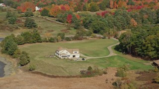 6K aerial stock footage flying by an isolated rural home, colorful forest, autumn, Newcastle, Maine Aerial Stock Footage | AX148_010E