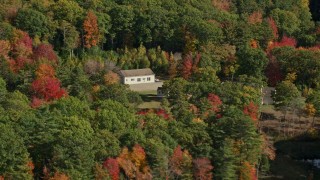 6K aerial stock footage flying by an isolated rural homes, colorful trees, autumn, Damariscotta, Maine Aerial Stock Footage | AX148_021