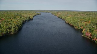 6K aerial stock footage flying by a colorful forest, over Biscay Pond, autumn, Damariscotta, Maine Aerial Stock Footage | AX148_022E