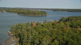 AX148_029 - 6K aerial stock footage approaching forested islands, The Narrows, autumn, Waldoboro, Maine