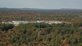 6K aerial stock footage flying by Maine State Prison, colorful forest, autumn, Warren, Maine Aerial Stock Footage | AX148_061