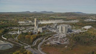 6K aerial stock footage flying by quarry and factory, scattered fall foliage, autumn, Thomaston, Maine Aerial Stock Footage | AX148_074