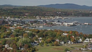 6K aerial stock footage flying by Rockland Harbor, small coastal town, autumn, Rockland, Maine Aerial Stock Footage | AX148_077E