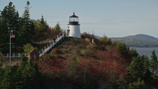 AX148_086E - 6K aerial stock footage orbiting Owls Head Light, fall foliage, autumn, Owls Head, Maine