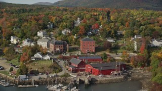 AX148_094E - 6K aerial stock footage flying over boats, Rockport Harbor, approach small coastal town, Rockport, Maine