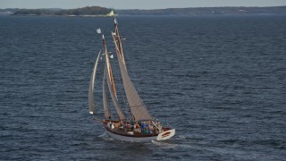 6K aerial stock footage orbiting a sailboat on West Penobscot Bay, Rockport, Maine Aerial Stock Footage | AX148_107E