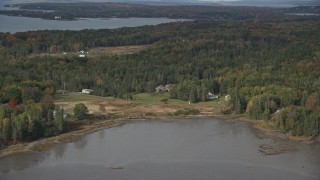 AX148_127 - 6K aerial stock footage flying by rural autumn, Isleboro Island, autumn, Islesboro, Maine