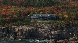 AX148_172 - 5.5K aerial stock footage flying by an isolated waterfront mansion, autumn, Seal Harbor, Mount Desert Island,  Maine