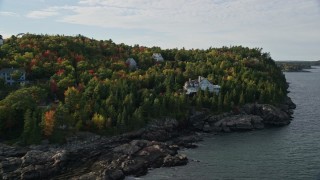 5.5K aerial stock footage flying by forested coastline, reveal waterfront mansion, Bar Harbor, Maine Aerial Stock Footage | AX148_188E