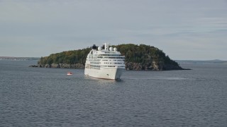 AX148_194 - 5.5K aerial stock footage flying by a cruise ship, tiny island, Bar Harbor, Maine