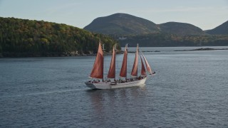 AX148_198 - 5.5K aerial stock footage sailing ship and partial fall foliage, Bar Harbor, Maine