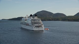 AX148_200 - 5.5K aerial stock footage tracking a cruise ship set against a tiny island, Bar Harbor, Maine