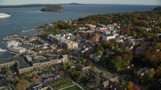 AX148_202E - 5.5K aerial stock footage orbiting Harborside Hotel, Spa & Marina in coastal town, autumn, Bar Harbor, Maine