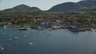 5.5K aerial stock footage flying over color changing trees toward harbor and coastal town, autumn, Bar Harbor, Maine Aerial Stock Footage | AX148_211E