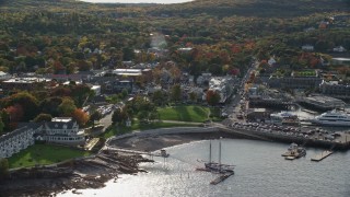 5.5K aerial stock footage of fall foliage in a coastal town near the harbor, Bar Harbor, Maine Aerial Stock Footage | AX148_219E