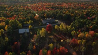 5.5K aerial stock footage flying over and tilt down on isolated home among fall foliage, Blue Hill, Maine Aerial Stock Footage | AX149_038