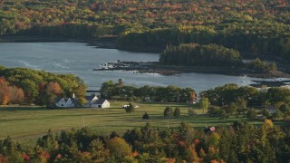 5.5K aerial stock footage flying by an isolated home, colorful foliage, autumn, Penobscot, Maine Aerial Stock Footage | AX149_063E