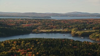 5.5K aerial stock footage flying by rural waterfront homes, Bagaduce River, forest, autumn, Penobscot, Maine Aerial Stock Footage | AX149_067