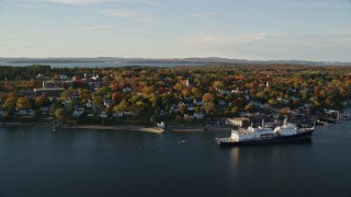 5.5K aerial stock footage flying by a small coastal town, State of Maine training ship, autumn, Castine, Maine Aerial Stock Footage | AX149_069E