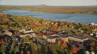 AX149_073E - 5.5K aerial stock footage orbiting the Maine Maritime Academy among fall foliage, autumn, Castine, Maine