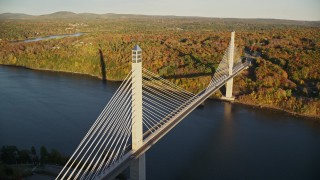 AX149_100E - 5.5K aerial stock footage flying by the Penobscot Narrows Bridge, autumn, Stockton Springs,  Maine