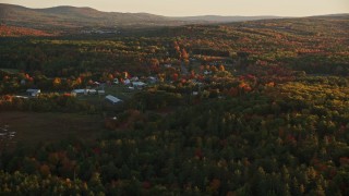 5.5K aerial stock footage approaching small rural town, colorful trees in autumn, Searsmont, Maine, sunset Aerial Stock Footage | AX149_174E