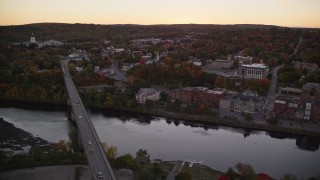 5.5K aerial stock footage flying by small bridges into downtown, Kennebec River, Autumn, Augusta, Maine, twilight Aerial Stock Footage | AX149_248