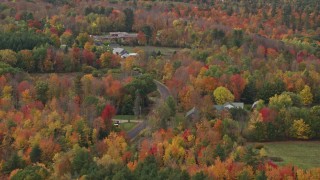 5.5K aerial stock footage flying by country road, colorful forest, autumn, Monmouth, Maine Aerial Stock Footage | AX150_028