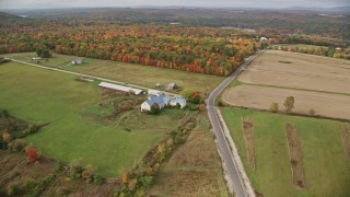 5.5K aerial stock footage flying over colorful trees, approaching a farm, autumn, Leeds, Maine Aerial Stock Footage | AX150_034E