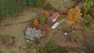 5.5K aerial stock footage flying by an old barn, colorful foliage in autumn, Turner, Maine Aerial Stock Footage | AX150_053