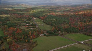 5.5K aerial stock footage flying by colorful first, Turner Street, rural homes, autumn, Buckfield, Maine Aerial Stock Footage | AX150_056E