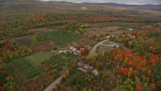 5.5K aerial stock footage flying over colorful forest, approaching Hill Road, autumn, Buckfield, Maine Aerial Stock Footage | AX150_058