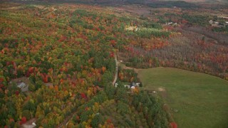 5.5K aerial stock footage flying over forest, approach rural homes near South Pond, autumn, Buckfield, Maine Aerial Stock Footage | AX150_059E