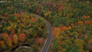 5.5K aerial stock footage flying over brightly colored forest, Buckfield Road, autumn, Paris, Maine Aerial Stock Footage | AX150_078E