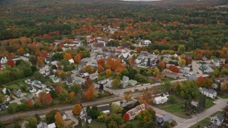 5.5K aerial stock footage orbiting brightly colored foliage throughout small rural town, autumn, Paris, Maine Aerial Stock Footage | AX150_085E