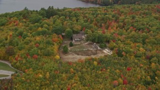 AX150_103 - 5.5K aerial stock footage approaching an isolated home, tilt down, autumn, Norway, Maine