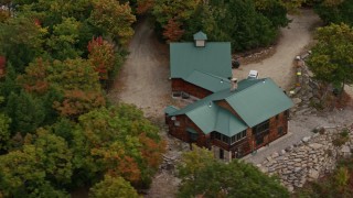 5.5K aerial stock footage flying by isolated home on a hilltop, colorful trees in autumn,  Norway, Maine Aerial Stock Footage | AX150_107