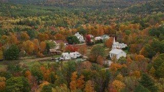 5.5K aerial stock footage orbiting a small rural town, revealing a church, autumn, Waterford, Maine Aerial Stock Footage | AX150_119E