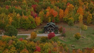 5.5K aerial stock footage flying by an isolated rural home, colorful forest, autumn, Waterford, Maine Aerial Stock Footage | AX150_125