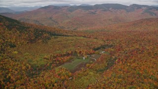 5.5K aerial stock footage approaching an isolated home, forest, tilt down, autumn, White Mountains, New Hampshire Aerial Stock Footage | AX150_185E