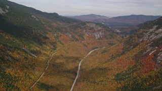 5.5K aerial stock footage flying over bright forest, Highway 302, autumn, overcast, White Mountains, New Hampshire Aerial Stock Footage | AX150_196E