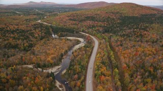 5.5K aerial stock footage flying over Highway 302 through forest, autumn, overcast, Carroll, New Hampshire Aerial Stock Footage | AX150_216