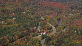 AX150_231E - 5.5K aerial stock footage fFlying by rural homes, Main Street, autumn, Bethlehem, New Hampshire