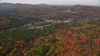 5.5K aerial stock footage flying over colorful forest, approach small rural town, autumn, Franconia, New Hampshire Aerial Stock Footage | AX150_238E