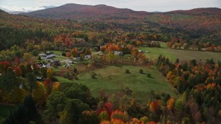 5.5K aerial stock footage approaching small rural town, colorful foliage, autumn, Sugar Hill, New Hampshire Aerial Stock Footage | AX150_246E