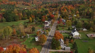 AX150_250E - 5.5K aerial stock footage flying over small rural town, approach Sugar Hill Road, autumn, Sugar Hill, New Hampshire