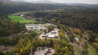 AX150_269 - 5.5K aerial stock footage approaching, flying by saw mill and tilt down, autumn, Bath, New Hampshire