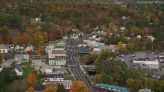 AX150_306 - 5.5K aerial stock footage flying by small rural town, tilting up Main Street, autumn, Wells River, Vermont