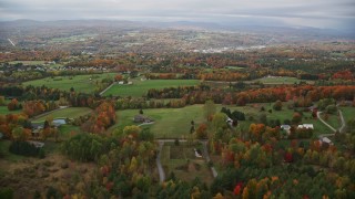 AX150_340E - 5.5K aerial stock footage flying over rural homes, colorful foliage, autumn, overcast, Barre, Vermont