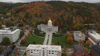 AX150_387E - 5.5K aerial stock footage approaching Vermont State House, buildings, foliage in autumn, Montpelier, Vermont